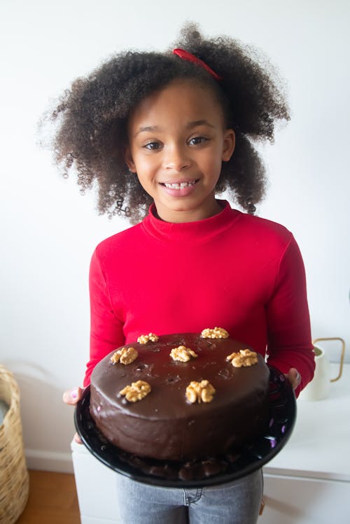 Free A Happy Girl Holding a Chocolate Cake Stock Photo