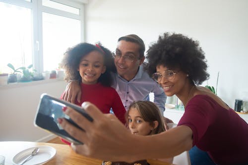 Free A Happy Family Taking a Group Selfie Stock Photo