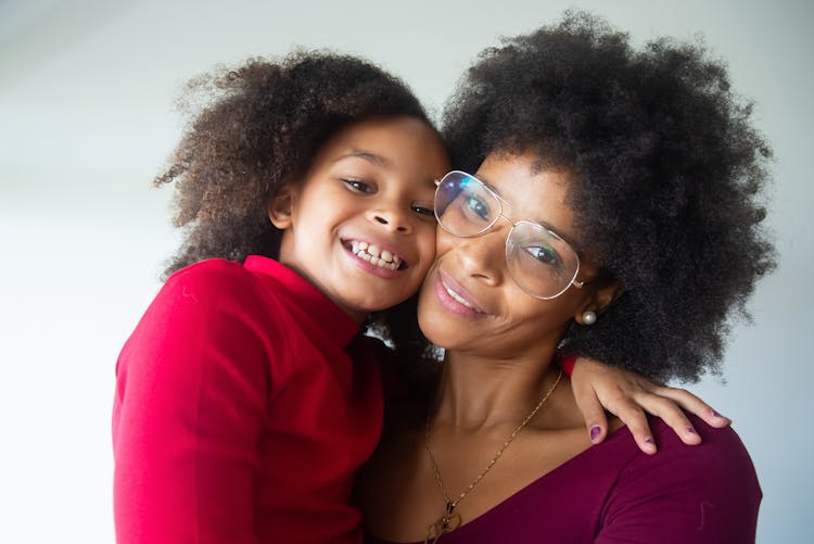 A Portrait Of A Happy Mom And Daughter