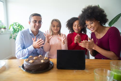 Free A Happy Family Clapping While Looking at a Tablet Stock Photo