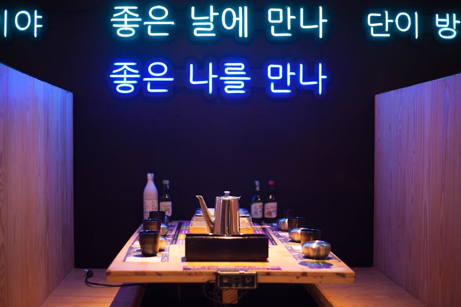 Stylish Korean dining booth adorned with vibrant neon signs for an inviting atmosphere.