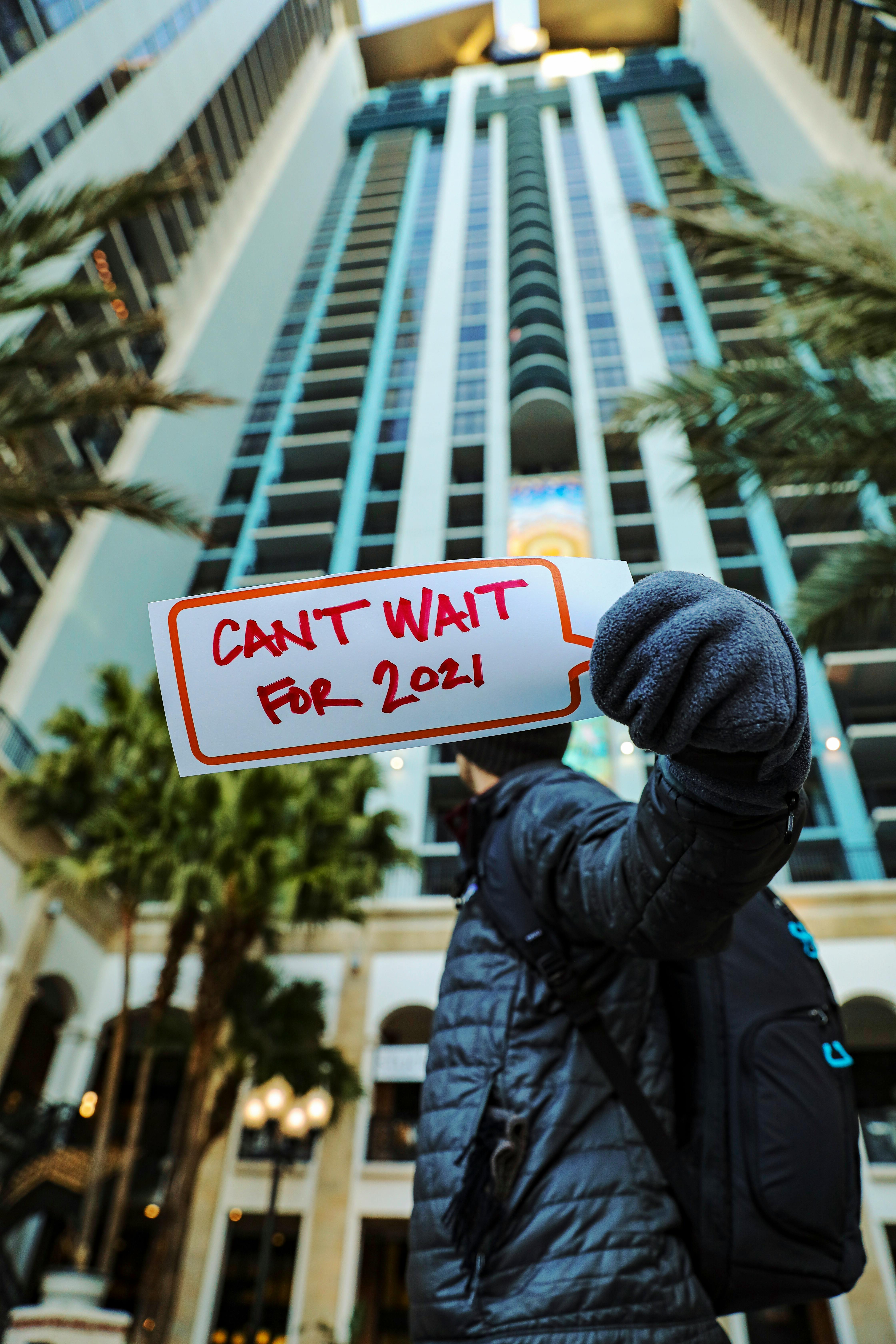 low angle shot of a person holding a placard