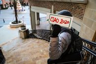 A Person Holding a Placard at a Stairway