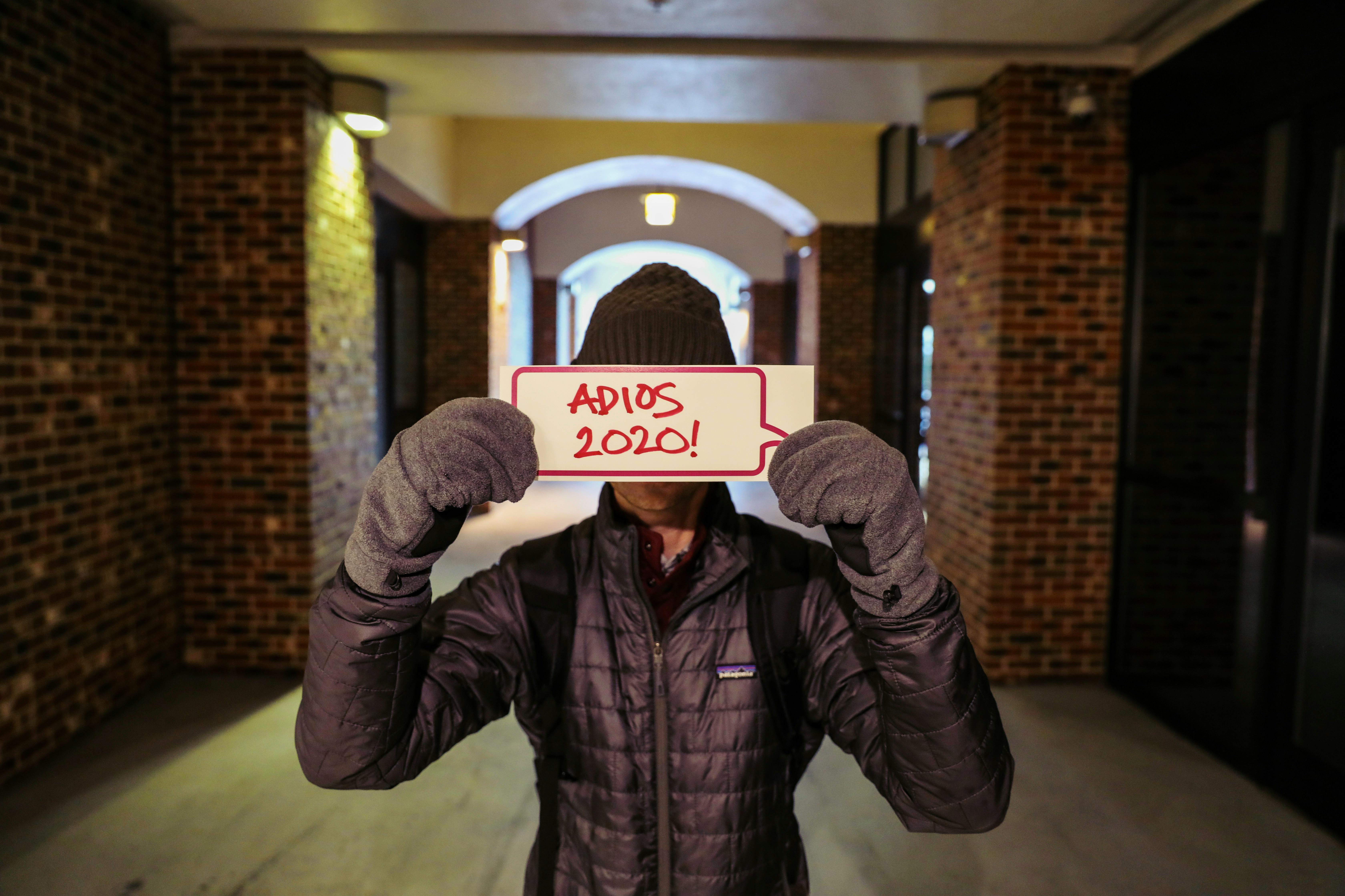 a person in a puffer jacket holding a placard