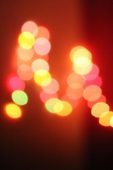 Vibrant blurred colored lights creating a warm bokeh effect suitable for wallpapers and backgrounds.