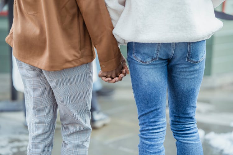 Crop Couple Holding Hands On Street