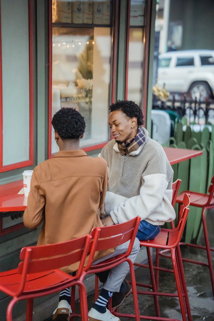 Cheerful Black Men Eating On Terrace Of Cafe