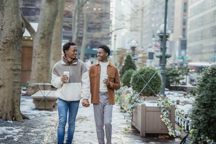 Positive Black Homosexual Men Walking On Snowy Sidewalk