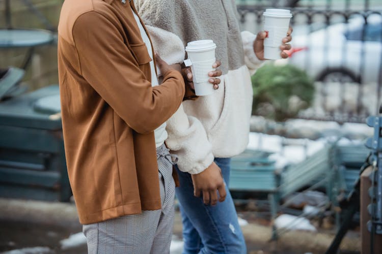 Crop Black Homosexual Couple With Coffee Walking On Street