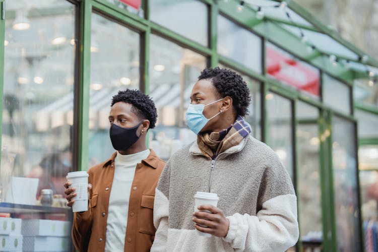 Black Men In Medical Masks With Takeaway Coffee On Street