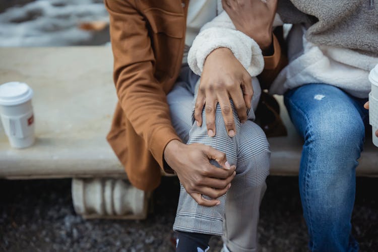 Crop Couple Sitting On Bench