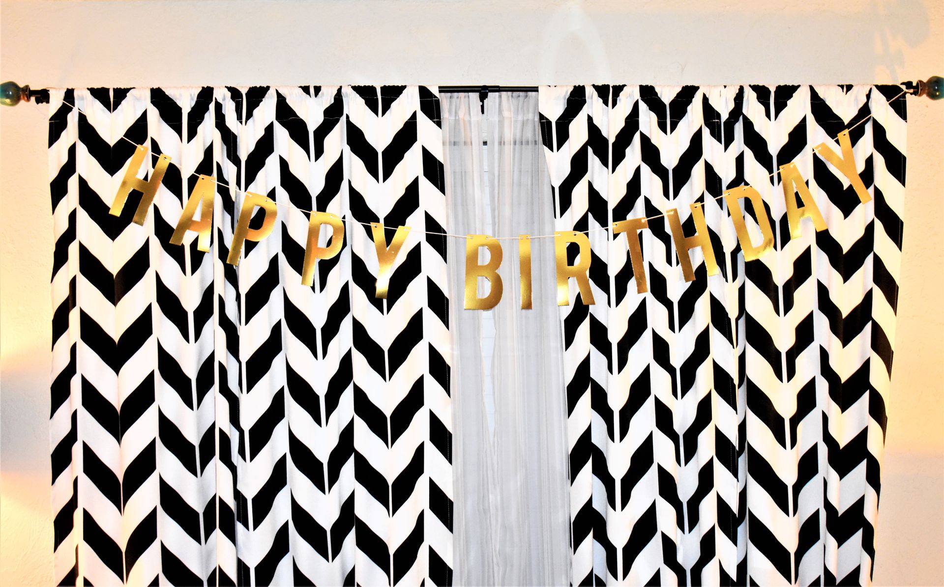 Hanging Birthday Banner Letters on a Window Pane