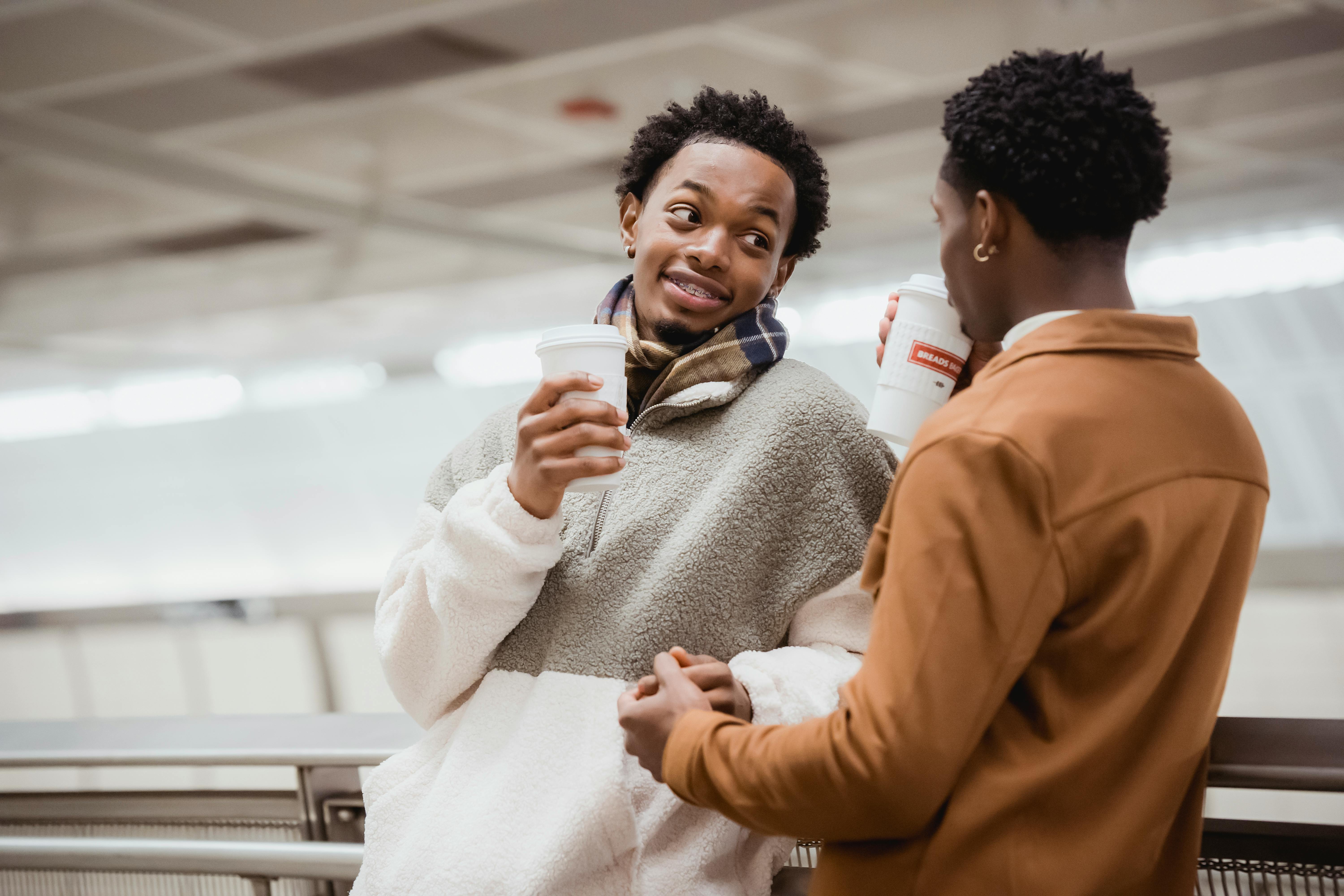 black couple holding hands and talking in underground