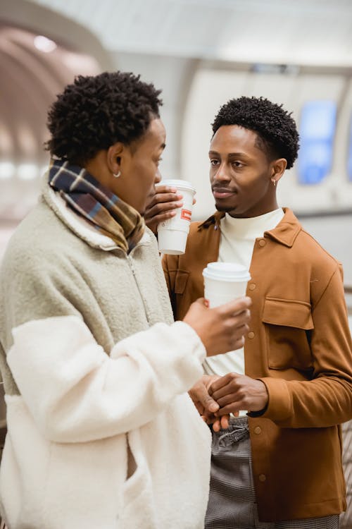 Free Black boyfriends with takeaway coffee talking Stock Photo