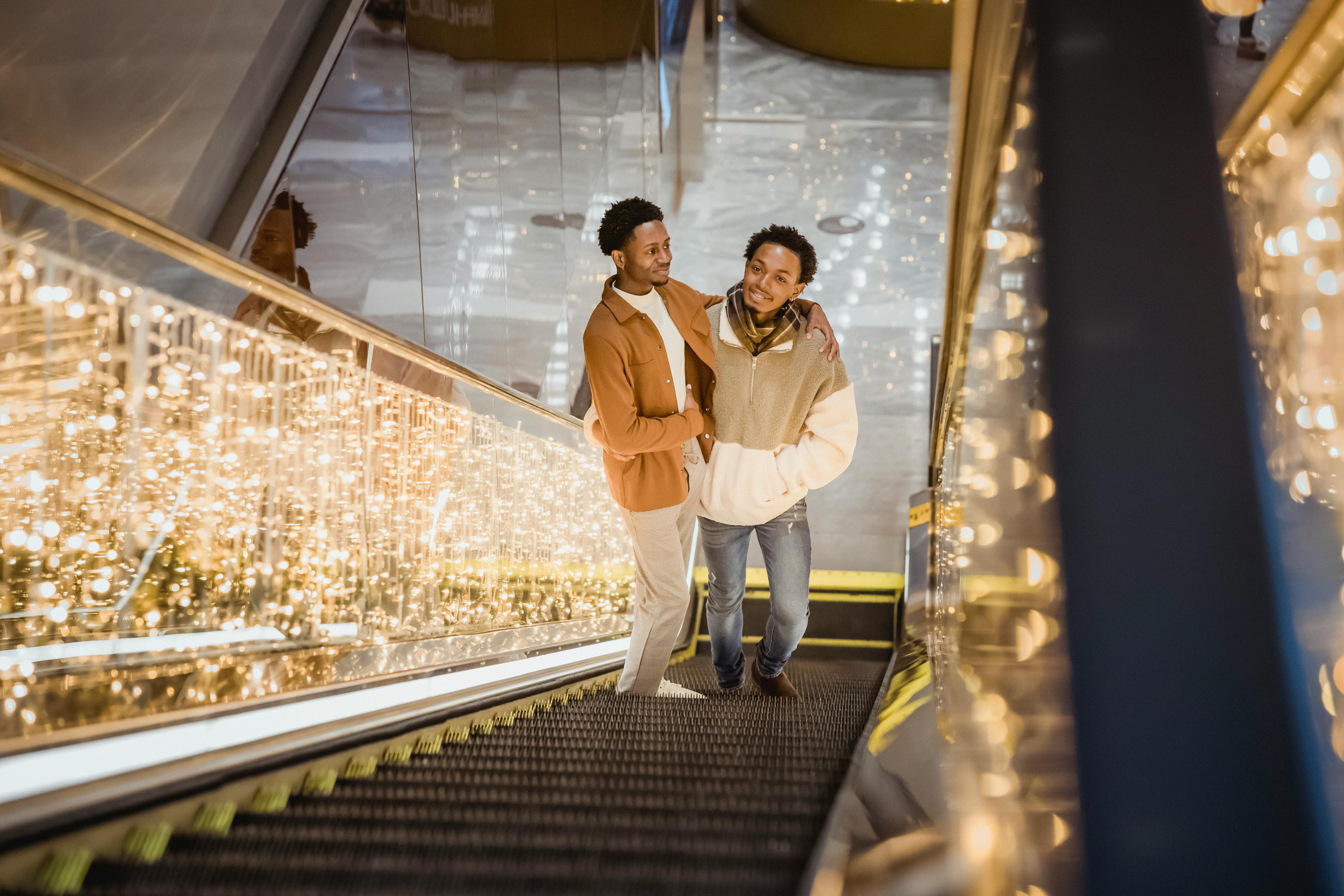 happy black couple embracing on escalator