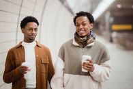 African American couple with coffee in subway