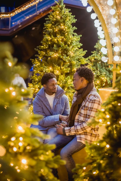 Romantic black homosexual couple near glowing trees