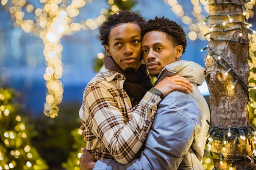 Romantic black gays hugging on street