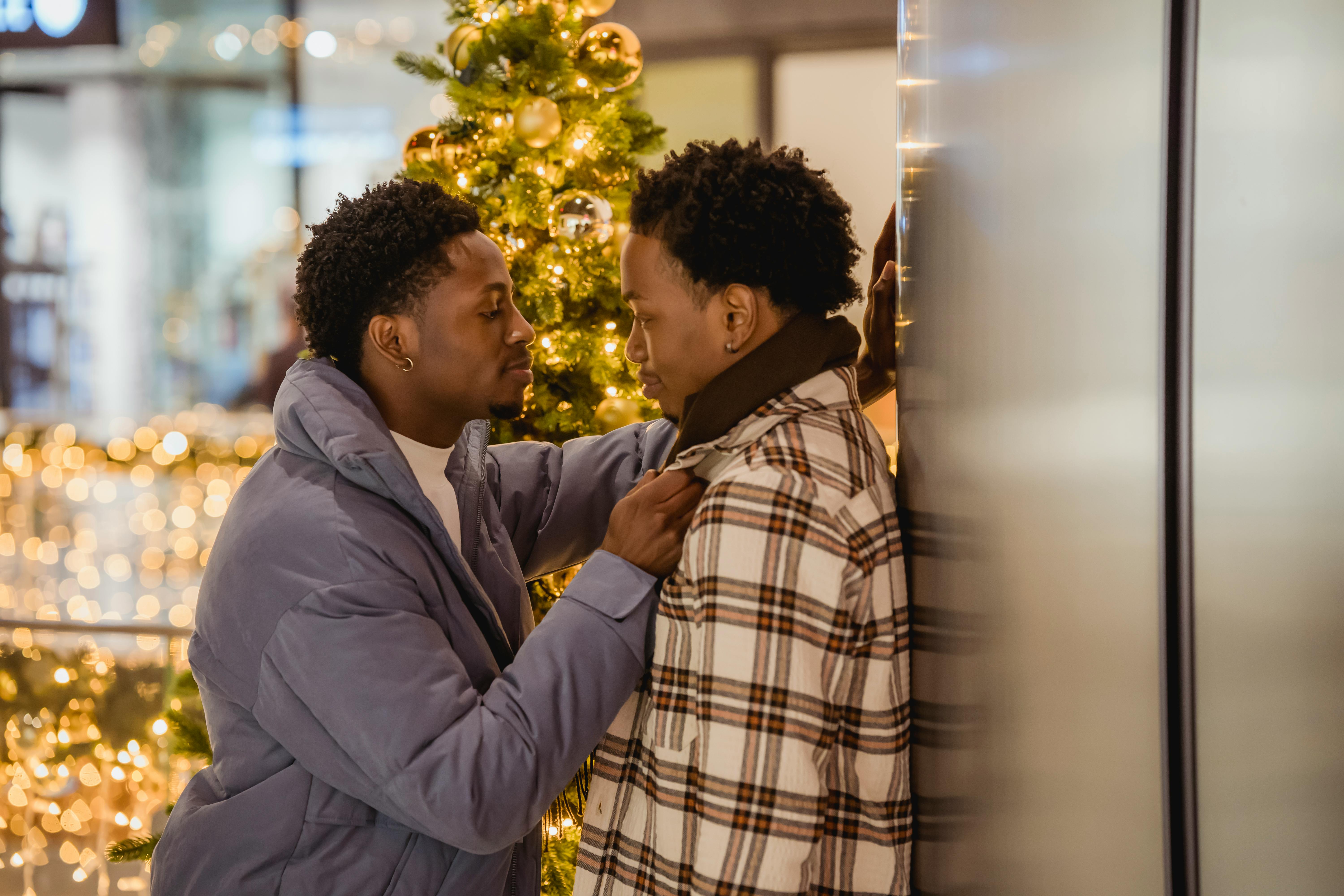 caring black man touching jacket of boyfriend