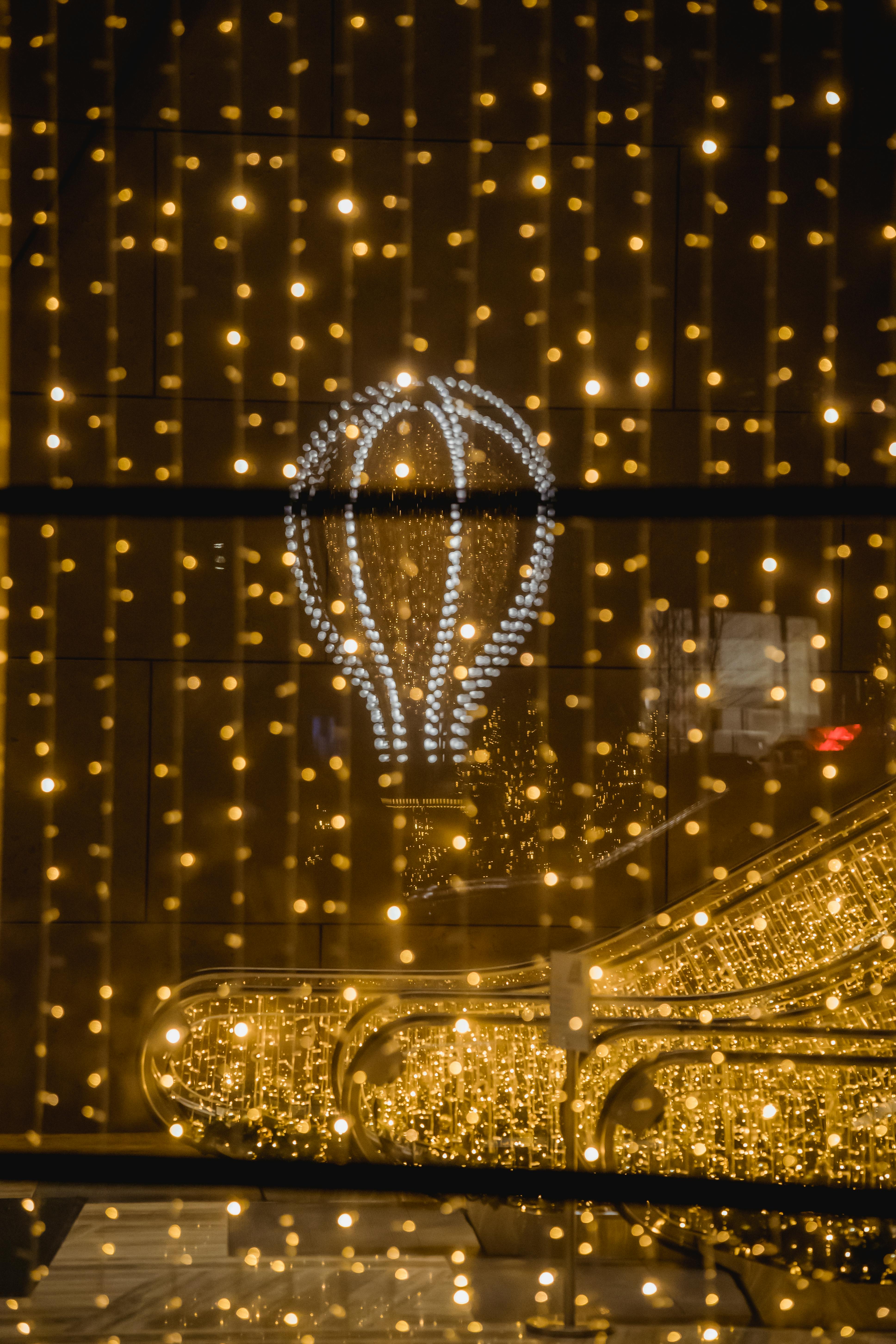 glowing bright air balloon among sparkling garlands in shopping center