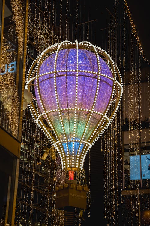 From below of balloon with glowing luminous Christmas lights hanging in tower in New York