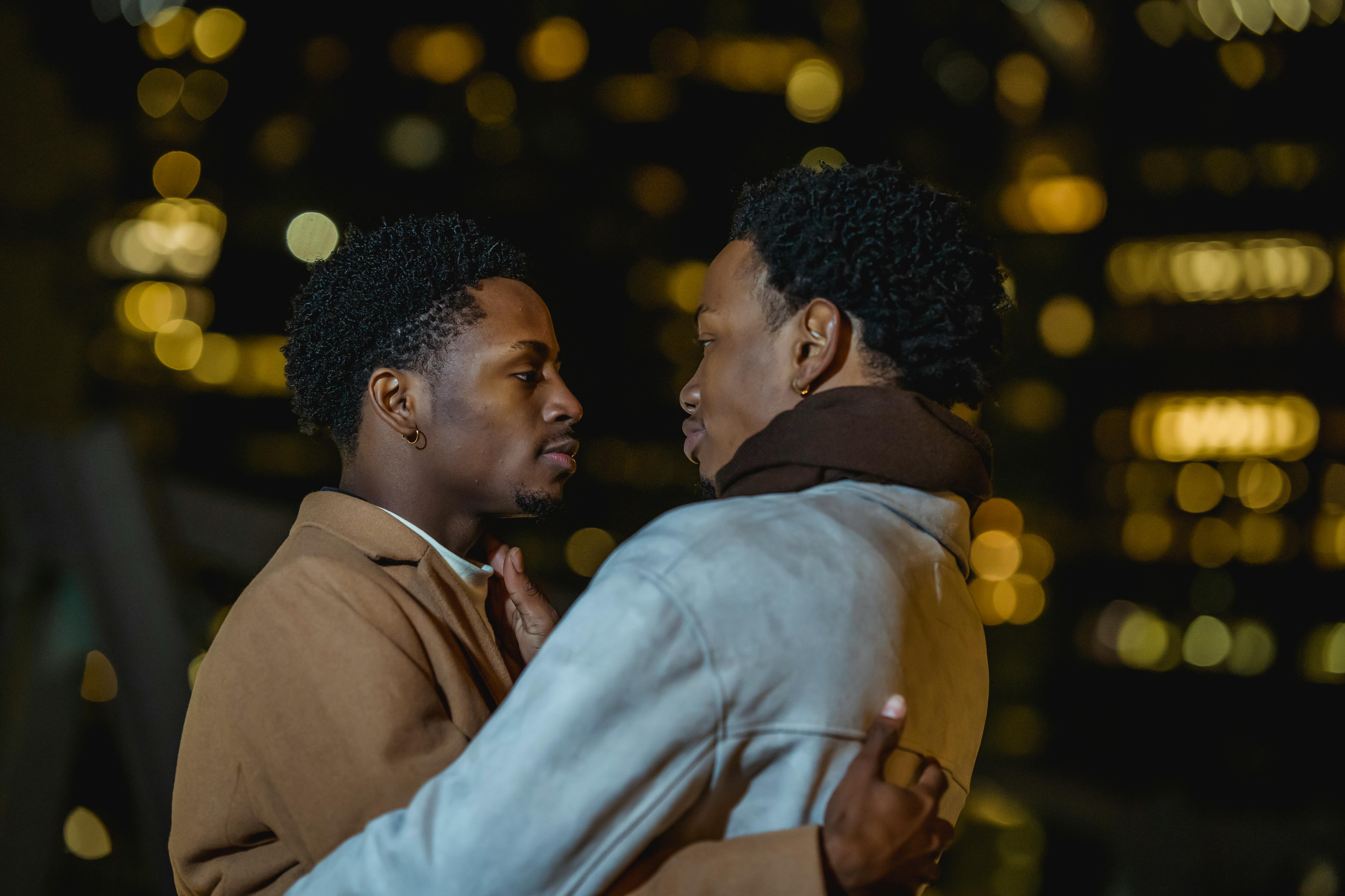 black same sex couple embracing at night