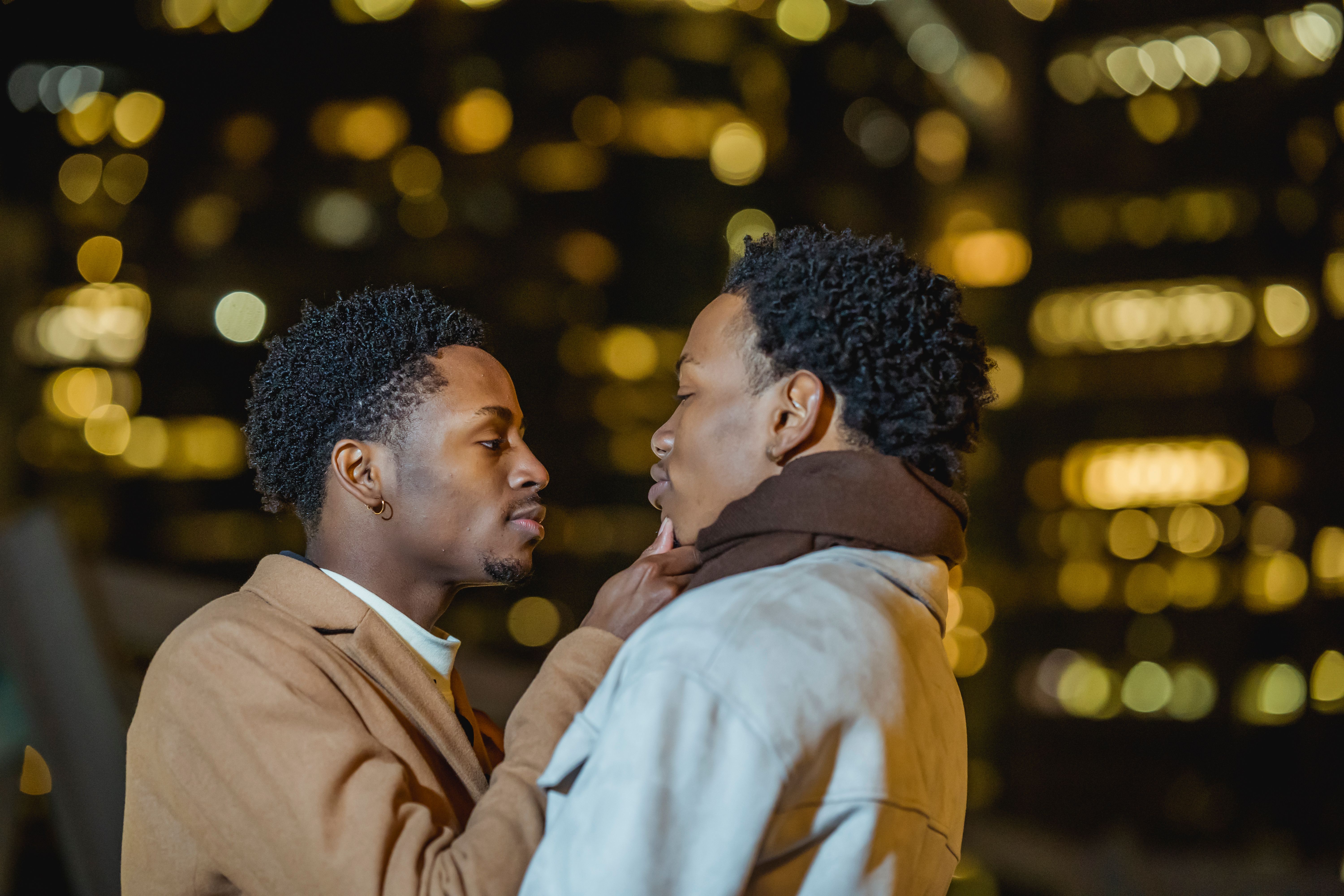 Close embrace between two adults in warm lighting
