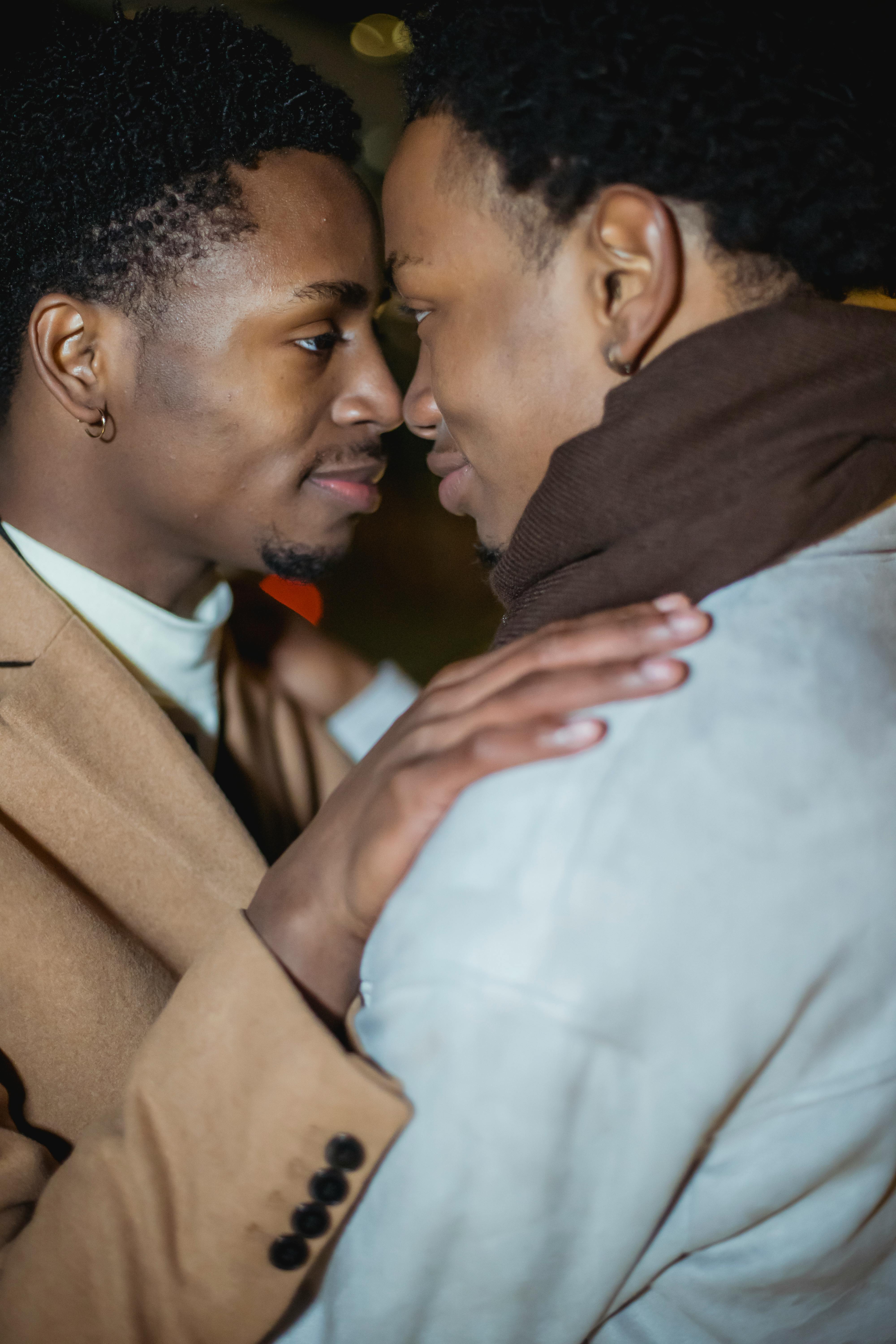 black homosexual male couple cuddling and looking at each other