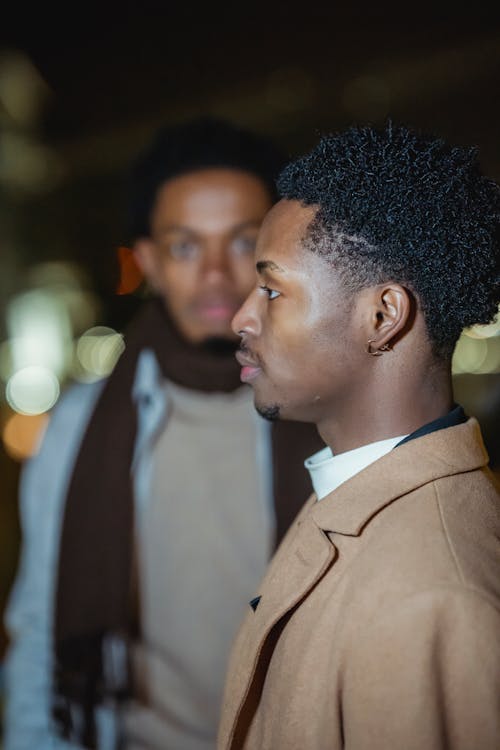 Black men standing on dark street · Free Stock Photo