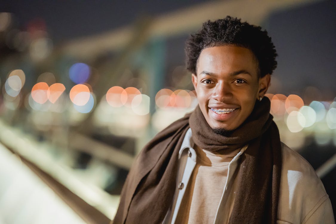 Smiling black man on evening street · Free Stock Photo