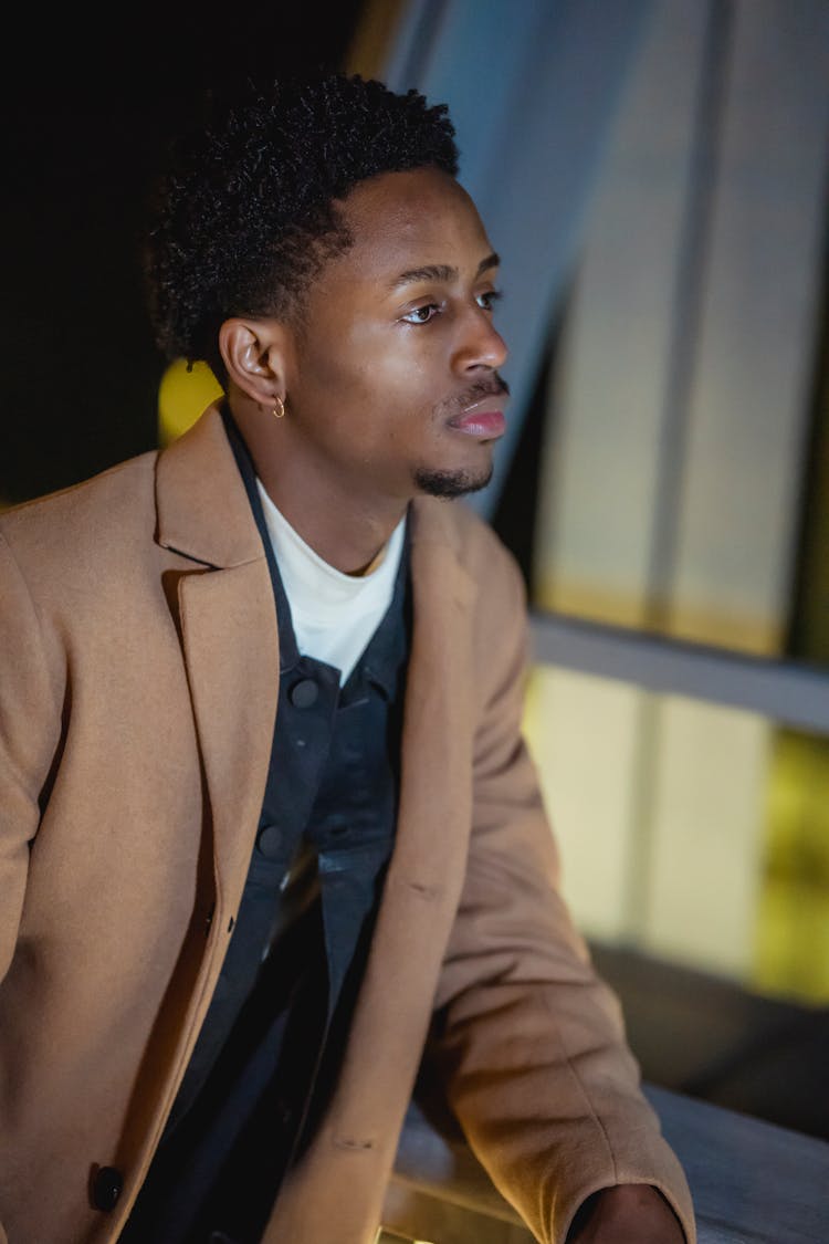 Serious Black Man Standing On Street In Evening Time