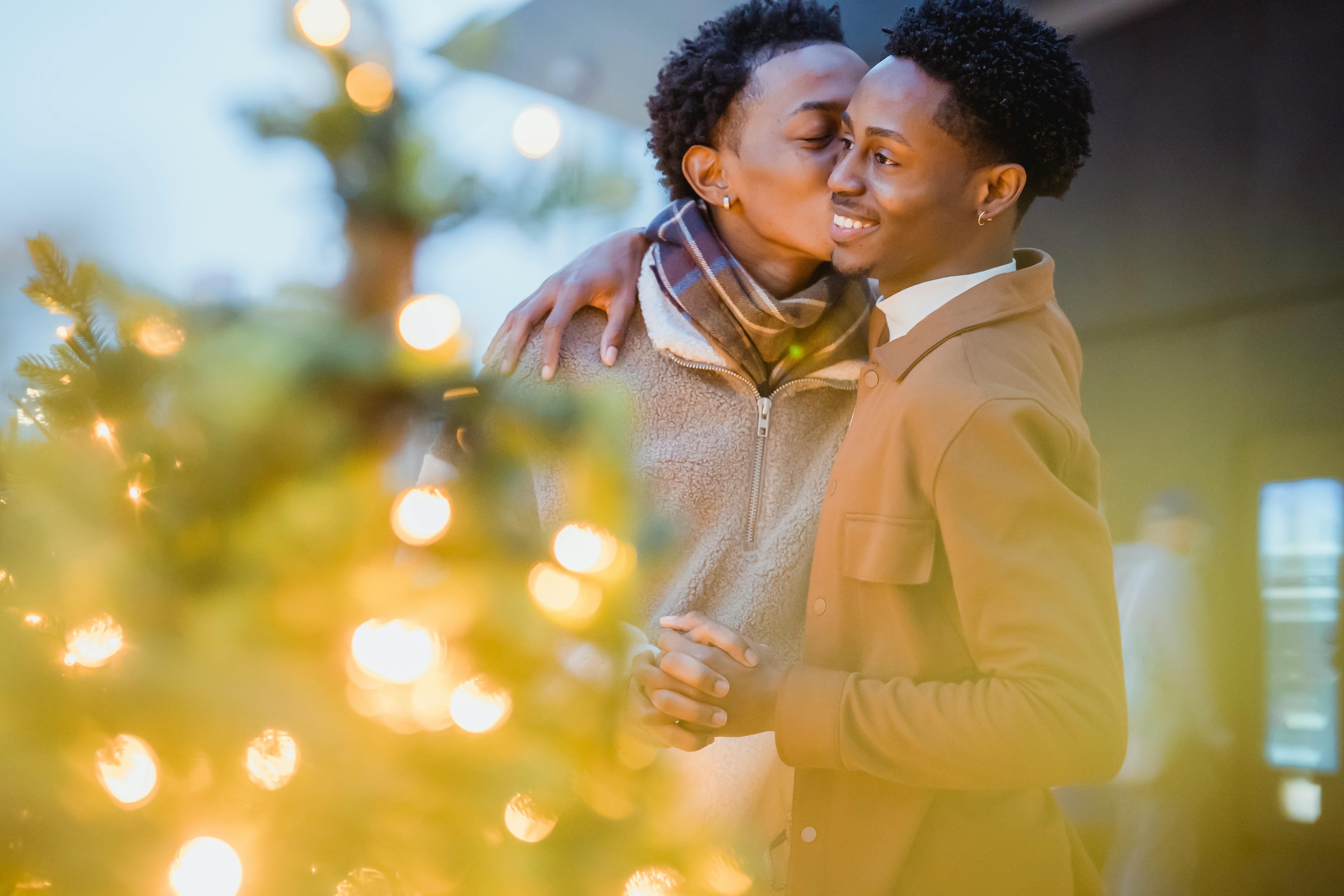 black man kissing homosexual boyfriend during new year holiday outdoors