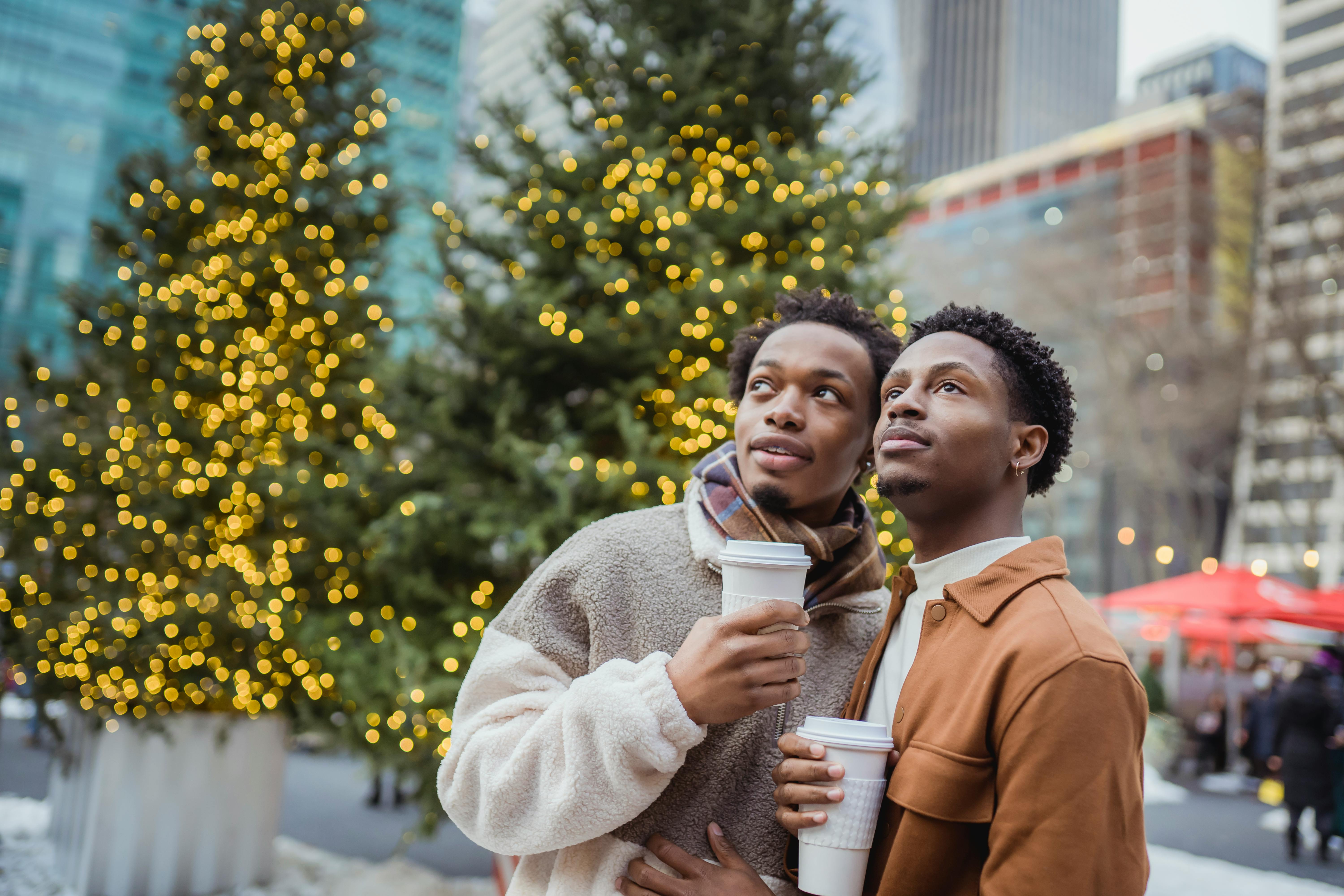 homosexual black couple with takeaway coffee on christmas day outdoors