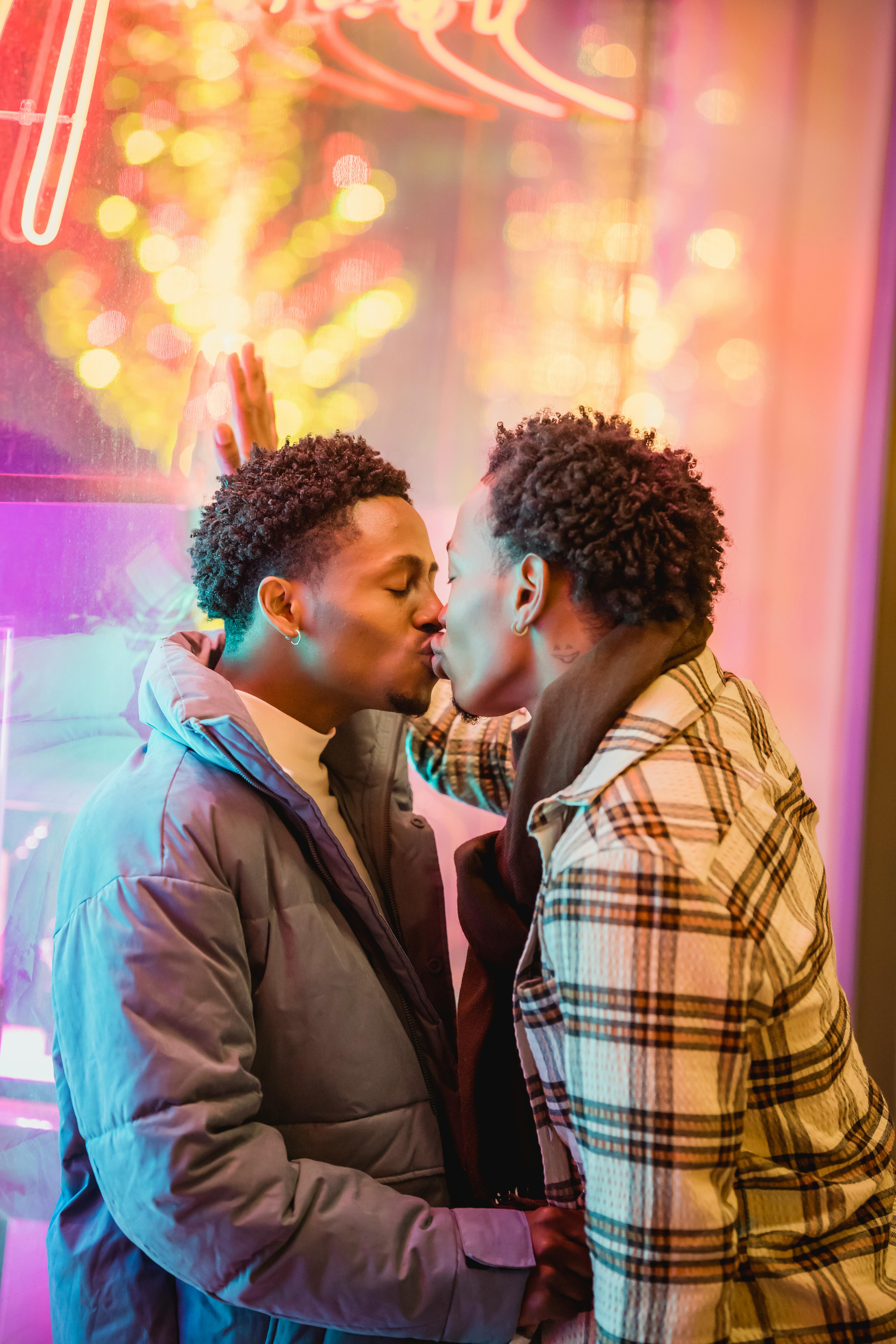 homosexual black couple kissing with closed eyes