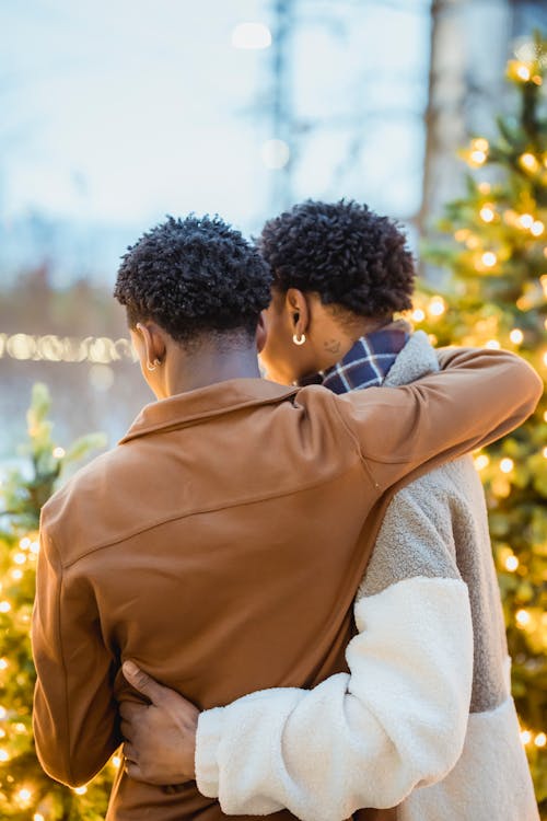 Unrecognizable black gays embracing on Christmas Day outdoors