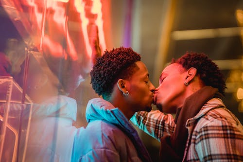 Homosexual black couple kissing with closed eyes
