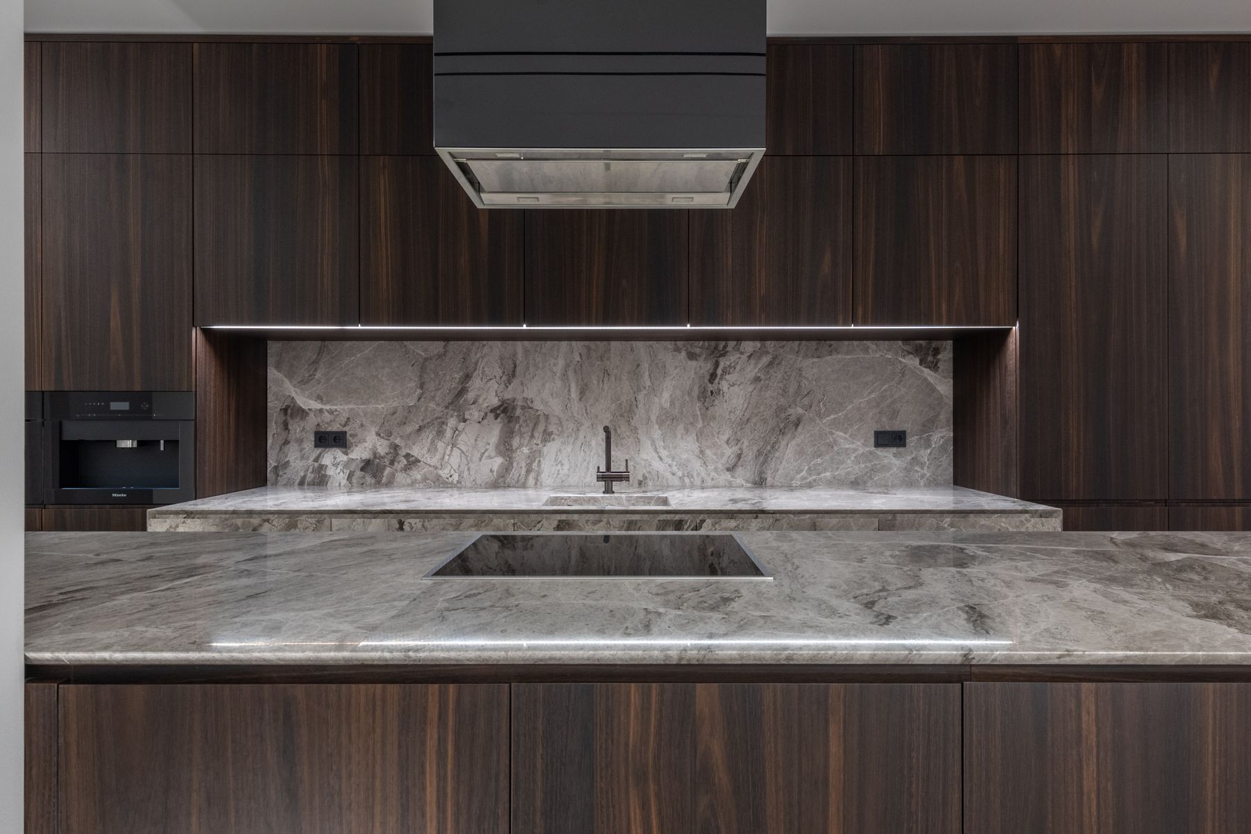 Quartzite Modern kitchen with grey quartzite waterfall island and matching backsplash