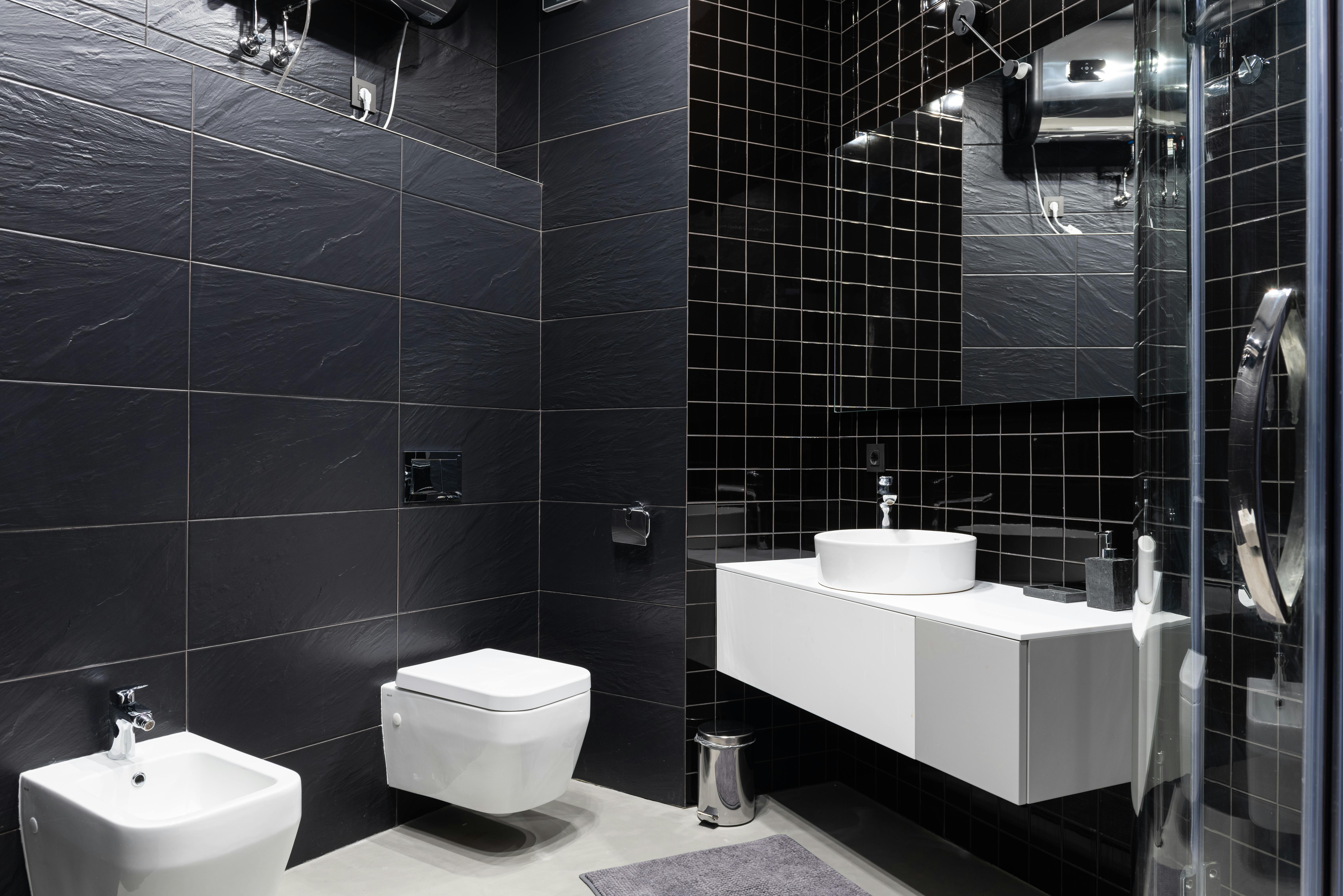 interior of restroom decorated with black tile