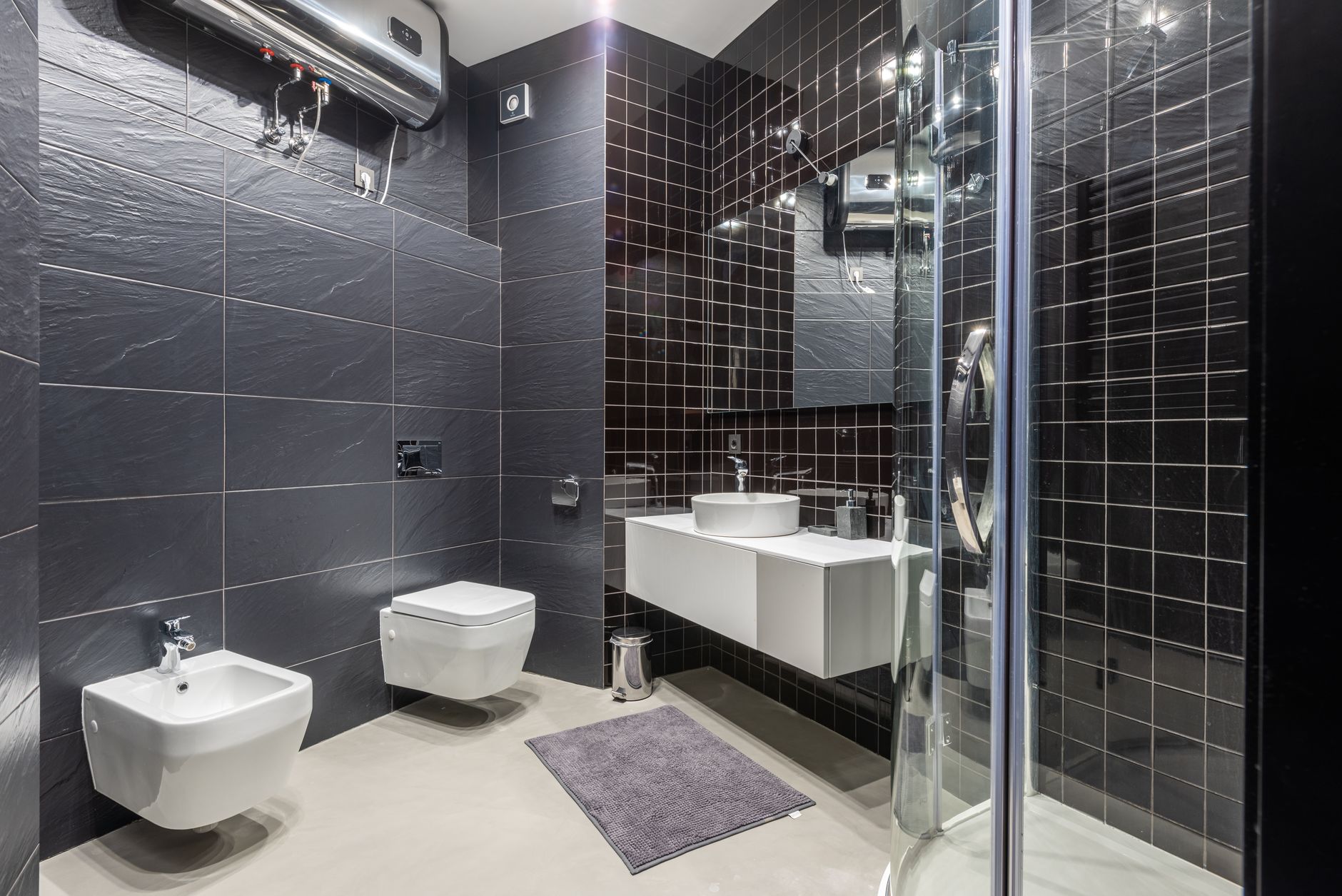 Charlotin Plumbing Services - Interior design of modern bathroom with shower and bidet decorated with black tile