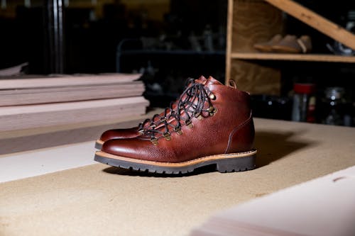 Free Brown Leather Boots on a Work Table Stock Photo