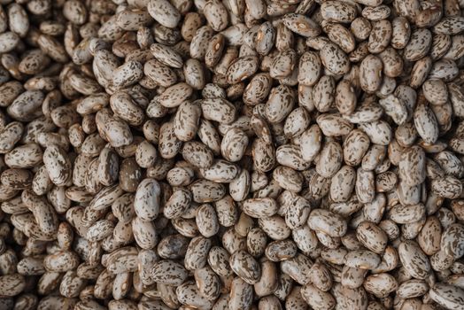 Detailed overhead shot of organic pinto beans showcasing a healthy, natural texture.