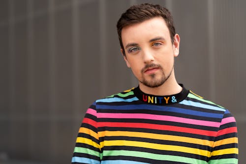 A Man Wearing a Rainbow Shirt