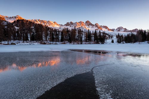 Montaña Cubierta De Nieve Cerca Del Cuerpo De Agua