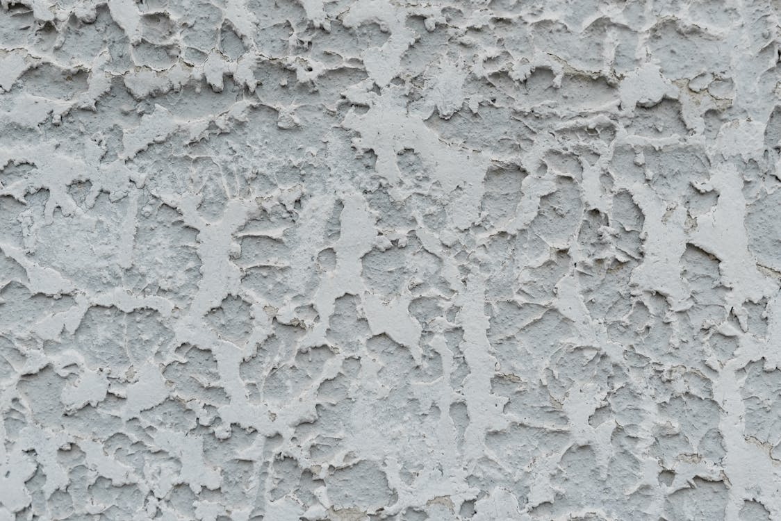 Free Cracked gray stucco wall with cracked surface Stock Photo