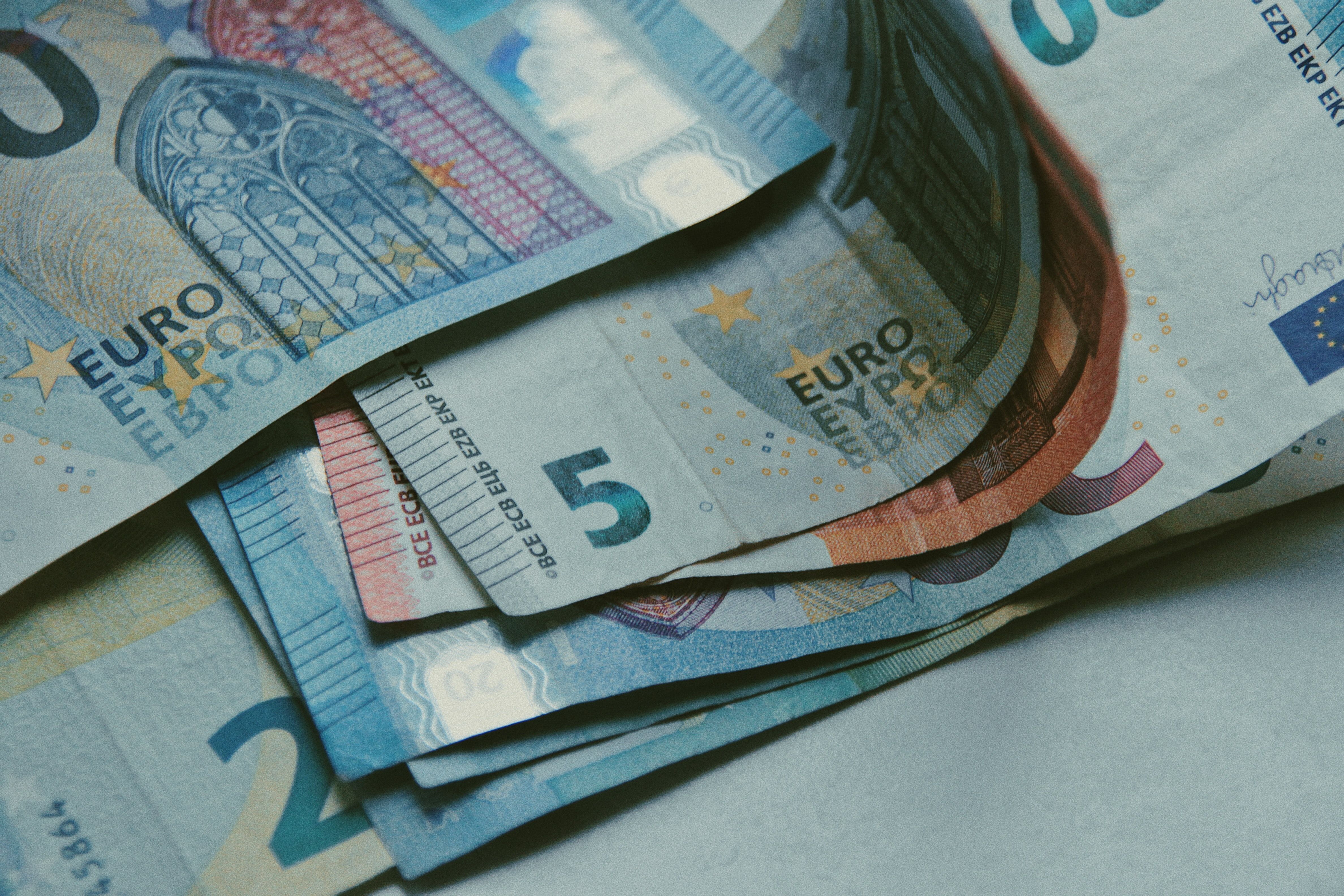 Close-up of assorted euro banknotes in different denominations spread in a small stack