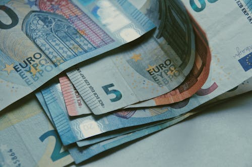 Close-up Shot of Euros on White Surface