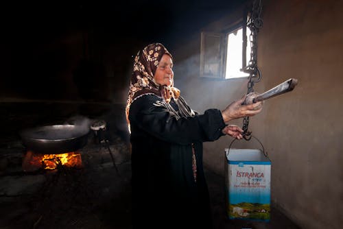 Elderly Woman Holding Box on Chain