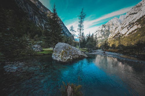 Peaceful lake amidst rocky mountains in wild valley