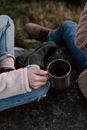 A Person in Denim Jeans Holding Stainless Mug