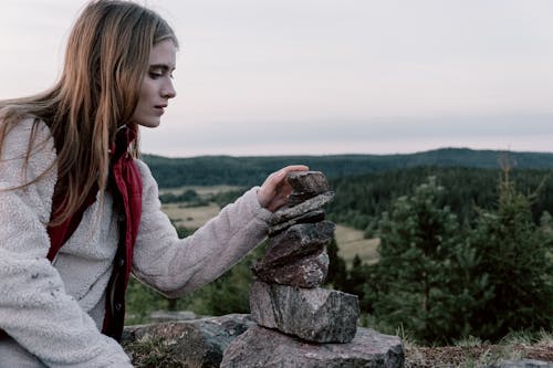 A Woman Stacking Rocks